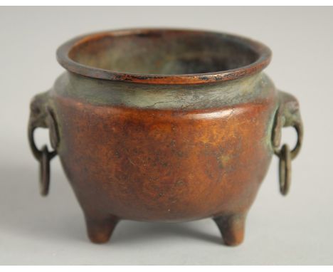A SMALL CHINESE BRONZE CIRCULAR CENSER with elephant handles. 2.25ins diameter.