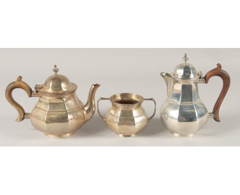 A THREE PIECE OCTAGONAL TEA SET, tea pot, hot water jug and sugar basin. Birmingham, mark rubbed, weight 22ozs.