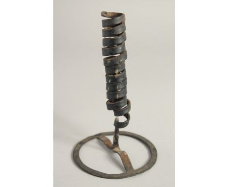 AN EARLY METAL CANDLESTICK. 7ins high.