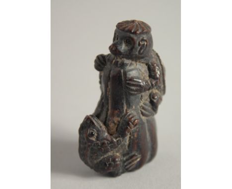 A WOODEN NETSUKE OF A FROG. 2ins