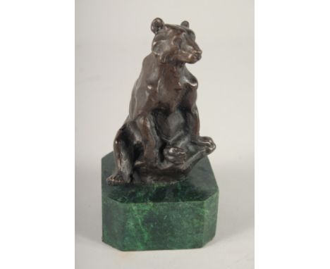 A SMALL BRONZE OF A BEAR. 5ins high on a marble base.