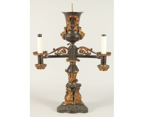 THOMAS MESSENGER. A REGENCY BRONZE AND ORMOLU TWO LIGHT CANDELABRA with outstretched arms and an urn finial on a stepped base