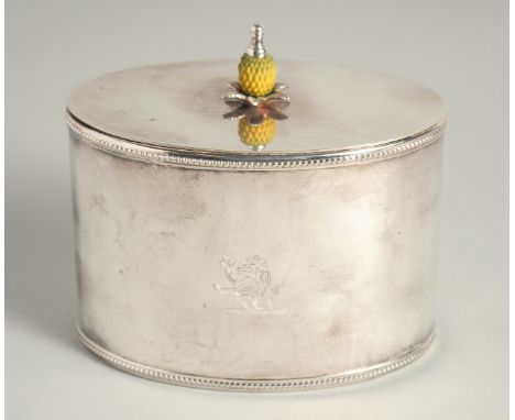 A REPRODUCTION SILVER PLATED OVAL TEA CADDY with pineapple final with crest.