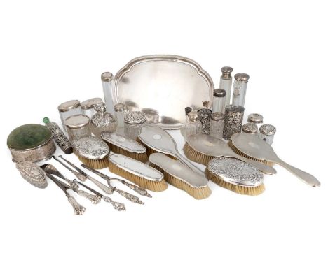 A mixed lot of silver dressing table items,various dates and makers,comprising: an oval dressing table tray, eleven silver-mo
