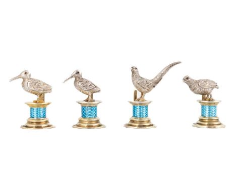 A matched set of four Edwardian silver gilt and enamel menu card holders,by William Edward Hurcomb, London 1909 and 1910,mode