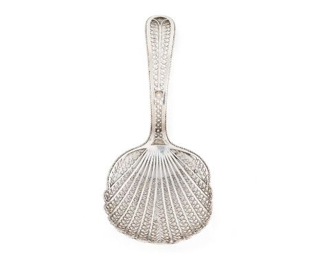 A George III silver filigree caddy spoon, unmarked circa 1800, shell-shaped bowl, scroll decoration, length 9.8cm, approx. we