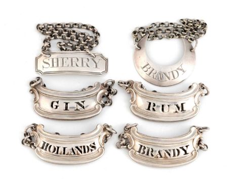 A set of four George IV silver wine labels  maker's mark 'WE', possibly that of William Elliott, London 1826, scroll form wit