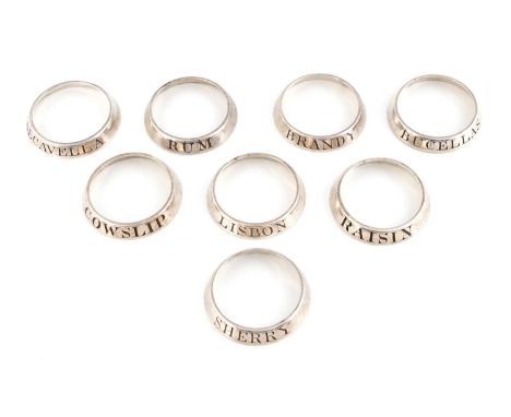A set of eight old Sheffield plate neck ring wine labels, unmarked, plain circular form, incised 'Lisbon', 'Cowslip', 'Calcav