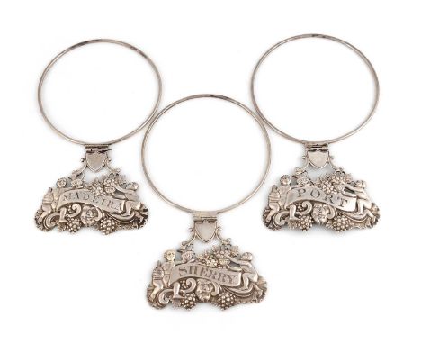 A set of three George III silver neck ring wine labels,by Matthew Linwood, Birmingham 1806,shaped oval form, with two Bacchan