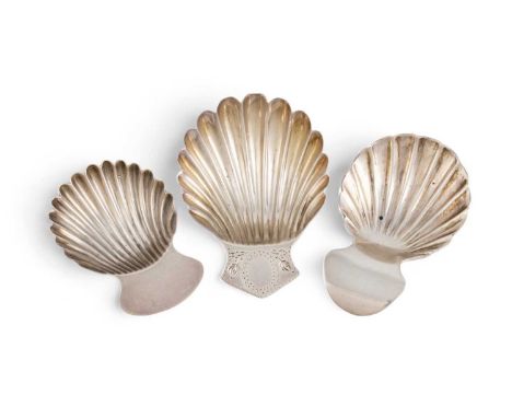 A collection of three George III silver caddy spoons, shell-shaped bowls, short handles, one engraved comprising: one by Eley