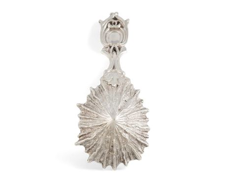 A William IV cast silver limpet caddy spoon, by William Traies, London 1834, with a pierced handle, engraved with a crest, gi