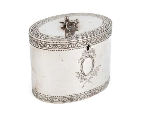 A George III silver tea caddy,by Aaron Lestourgeon, London 1774,oval form, engraved decoration, flush-hinged cover with a fol