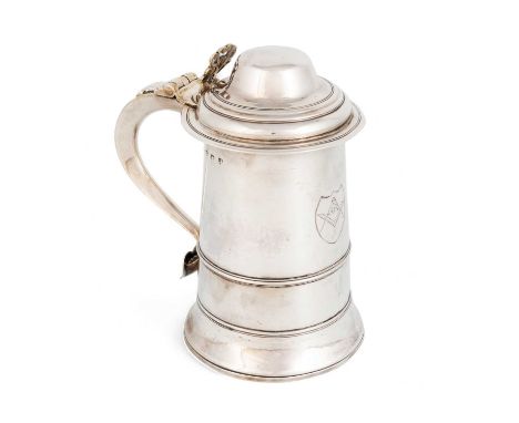 A George III silver tankard, by James Stamp, London 1779, tapering circular form, central girdle, scroll handle with a heart-