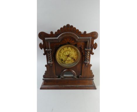 A Late 19th Century American Gingerbread Clock with Brass Dial, by the Waterbury Clock Company, New York, 40cm High 