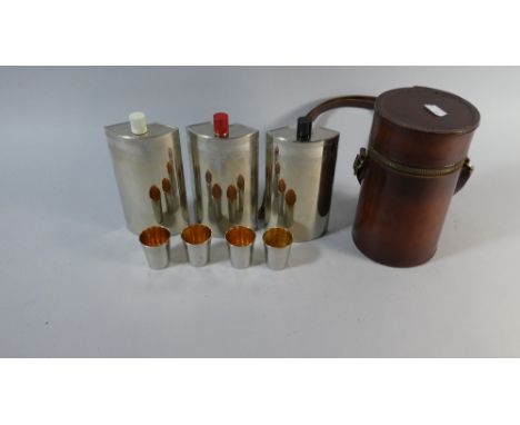 A Cylindrical Leather Cased Three Decanter and Four Tot Set, 18cm High 