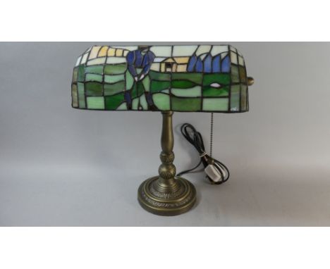 A Reproduction Desk Top Table Lamp with Tiffany Style Shade Depicting Golfer 