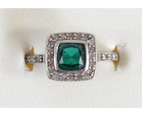 An Art Deco style white gold, synthetic emerald and diamond cluster ring, tests as 9ct, collet set with a mixed cut stone bor