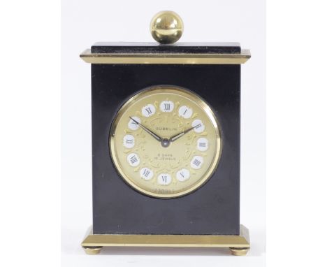 Gubelin, a gilt brass and black lacquer 8 day manual wind alarm clock, numbered 665387, 9.5 x 7cm. 