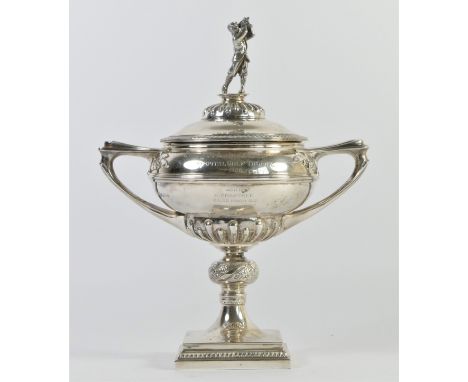 A silver golfing trophy, by Manoah Rhodes, Sheffield 1925, the pull off cover with a golfer in full swing, the two handled va