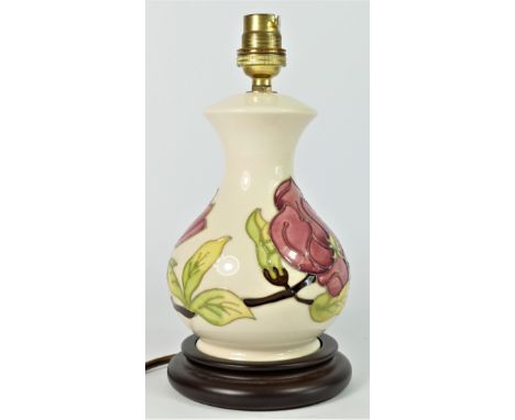 A Moorcroft Pink Magnolia tube lined pottery table lamp, mounted on a wood effect base, with fitting, 25cm 