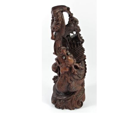 A Chinese carved rootwood statue, depicting a dragon chasing the sacred pearl, 35cm 