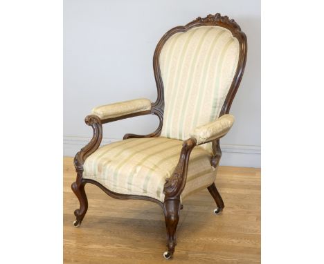 A Victorian carved mahogany button back parlour chair, padded arms, with carved cabriole front supports, 63 x 101 cm