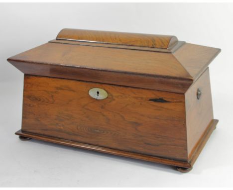 A Victorian rosewood sarcophagus tea caddy, hinged lid revealing two tea compartments with hinged lids and a central glass mi