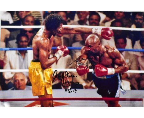 BOXING INTEREST; a colour photograph depicting Thomas 'Hitman' Hearns and Marvellous Marvin Haggler, bearing the signatures o