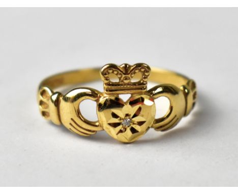 A 9ct gold claddagh ring set with small diamond.