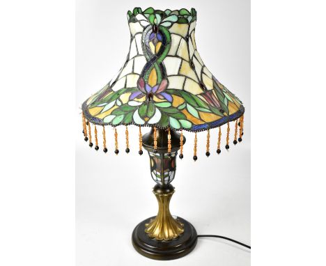 A Tiffany-style table lamp, Classical urn-shaped column to stepped circular base, with multi-coloured floral decorated shade 
