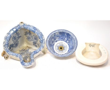 A late 19th/early 20th century blue and white transfer decorated wall-mounted corner urinal, a circular blue and white transf