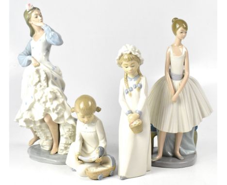 A Nao figure of a ballerina standing next to a stool, together with another Nao figure of a Flamenco dancer holding her ruffl