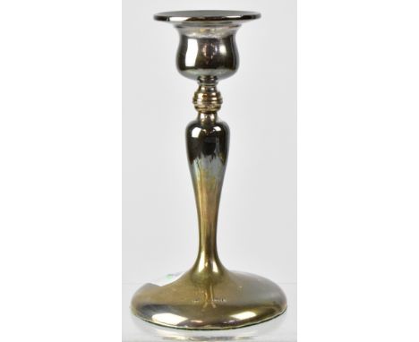 A hallmarked silver slender candlestick to sloping circular base, marks rubbed, height 15cm.