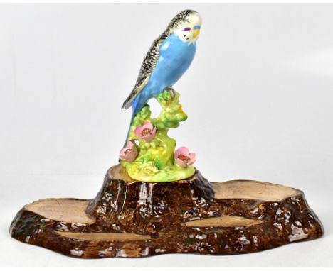 BESWICK; a model of a budgerigar, first version, on a naturalistic stylised base of tree and raised floral decoration, height