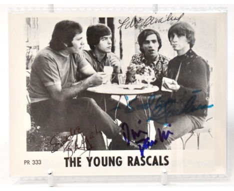 THE YOUNG RASCALS; a black and white photo card bearing signatures to the front and inscription with lyrics to the reverse.We