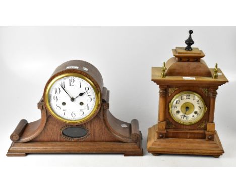 An early 20th century oak dome topped mantel clock, the enamelled dial set with Arabic numerals, movement striking on a coil,