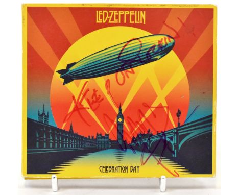 LED ZEPPELIN; 'Celebration Day' CD, inscribed 'Keep on rockin'!' and bearing three signatures to the folding sleeve.We have n