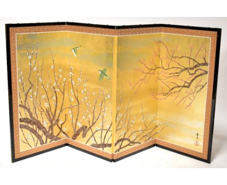 A modern black lacquered brass mounted three-fold four-panel silk lined Oriental screen with decoration of birds and blossom 