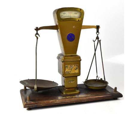 A pair of Burtons Autobac scales with blue circular maker's plaque to the middle of the metal scales, the whole mounted on an