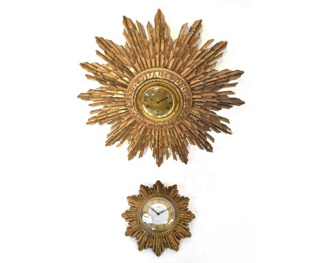 A 20th century eight day sunburst wall clock, the dial set with Roman numerals, width 47cm, and a similar smaller Smiths eigh