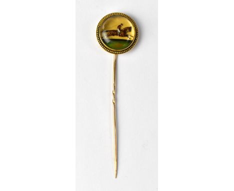 A late 19th century yellow metal stick/scarf pin, the Essex crystal cabochon head with reverse painted horse and jockey set w