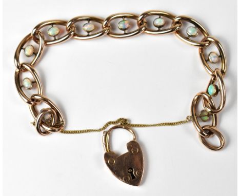 A vintage 9ct gold and opal oval link bracelet, each link with collet set oval opal, predominantly green and white, united wi