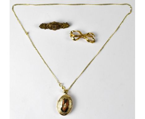 A modern 9ct gold oval double locket on 9ct gold dainty necklace chain, length approx 40cm, a 9ct gold bow brooch, length 3.5