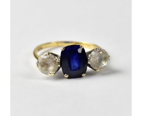 A 9ct yellow gold ring set with central oval blue stone and white stone to either side, size Q, approx 3g.