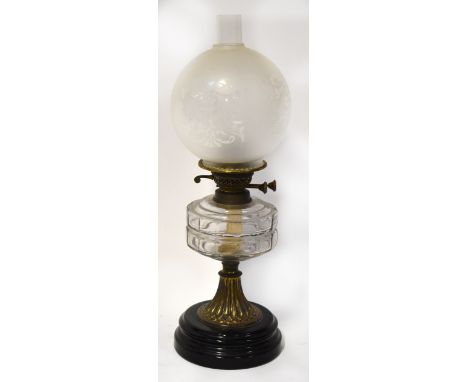 A 19th century paraffin lamp, the clear glass font with moulded square pattern, on tapered ormolu column, on circular black g