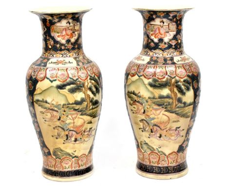 A pair of large 20th century Japanese Satsuma style vases decorated with gilt heightened panels depicting horseback archers r