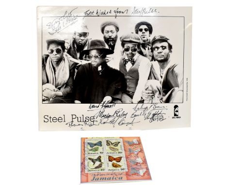 STEEL PULSE; a black and white photograph bearing various signatures of the band members along with a sheet of four Jamaican 
