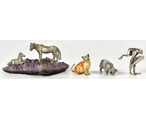Three hallmarked silver miniature models of animals comprising and enamelled seated cat, two frogs playing leapfrog, and a pi