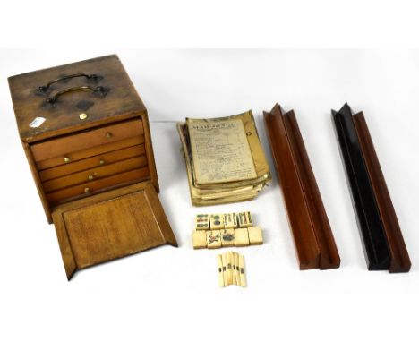 A Mahjong game with box containing five drawers of bone and bamboo counters and playing pieces together with a box of wooden 