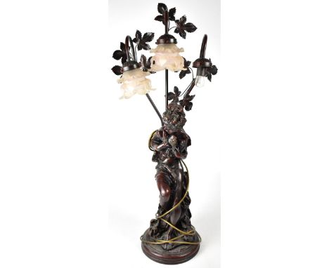 A contemporary Art Nouveau style bronzed three-branch metal table lamp, with partially clad young woman holding turtle doves,